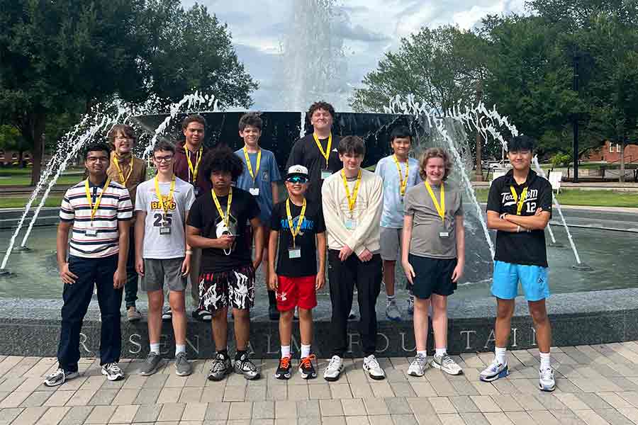 A group of teenaged boys in front of the fountain on campus Summer 2026