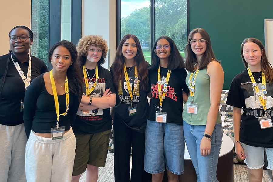 Group of teenaged girls standing together facing the camera at the Honors College at Baylor